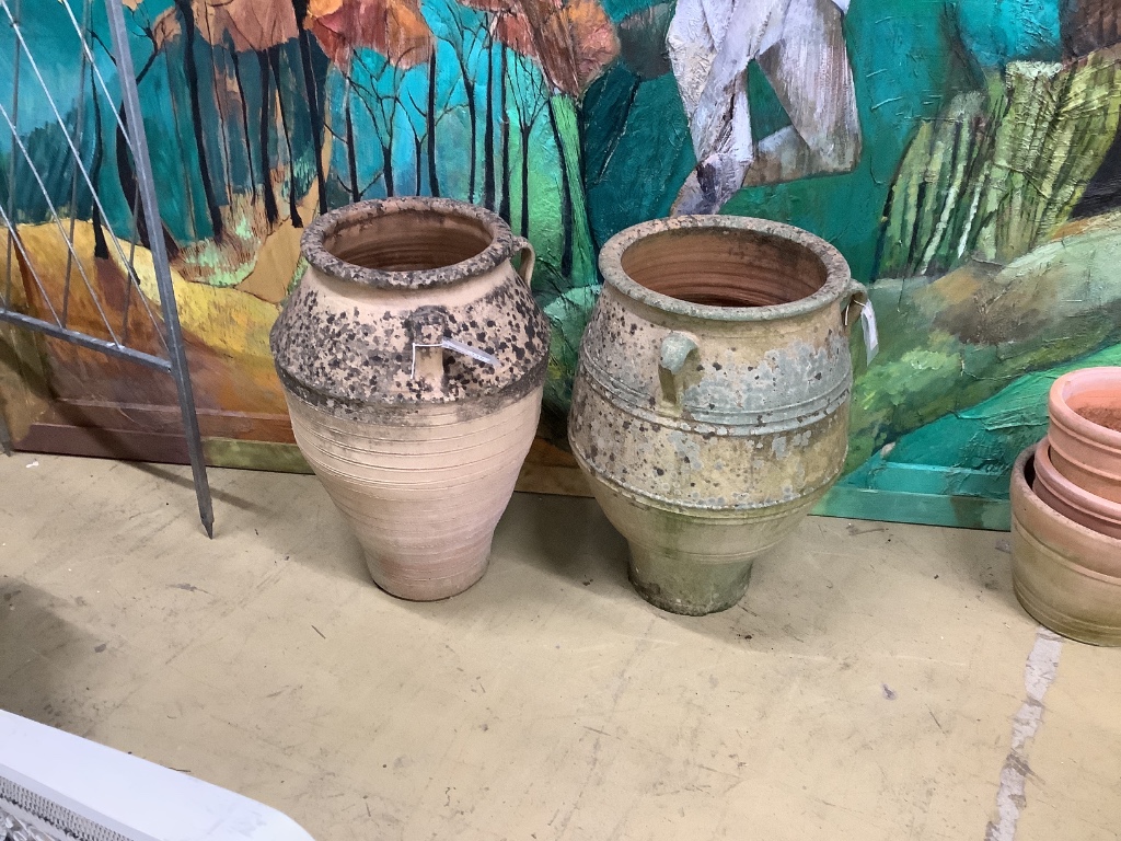 Two terracotta oil jars, larger 45cm diameter, height 69cm